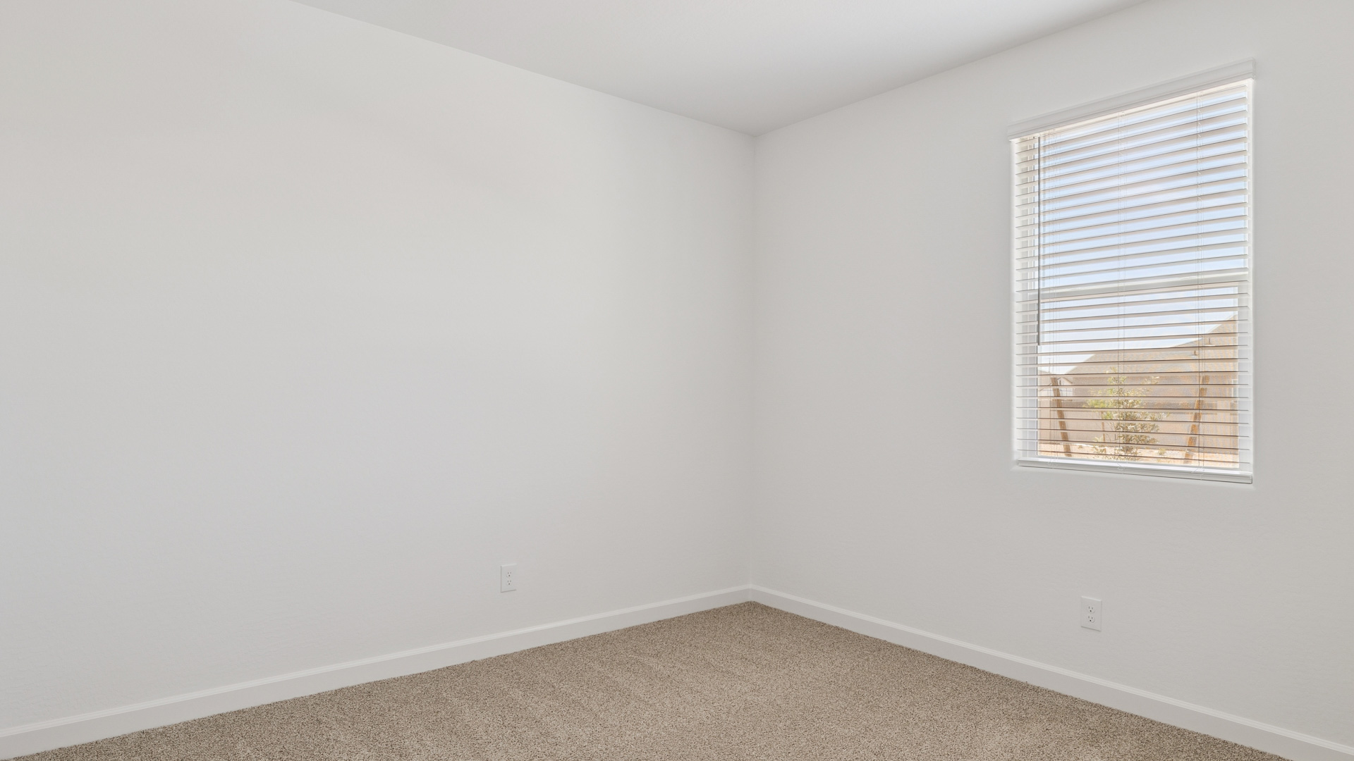 Comfortable guest bedroom featuring neutral-toned walls and a large closet.