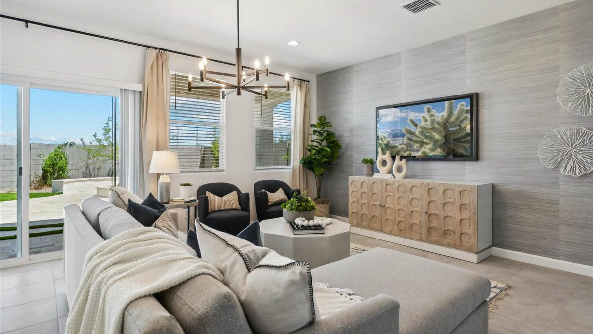 A well-organized living room that includes a kitchen and dining area, creating a warm and welcoming environment for gatherings.