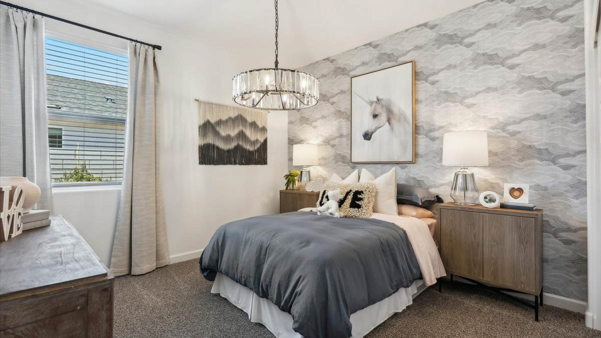Comfortable guest bedroom featuring neutral-toned walls and a large closet.