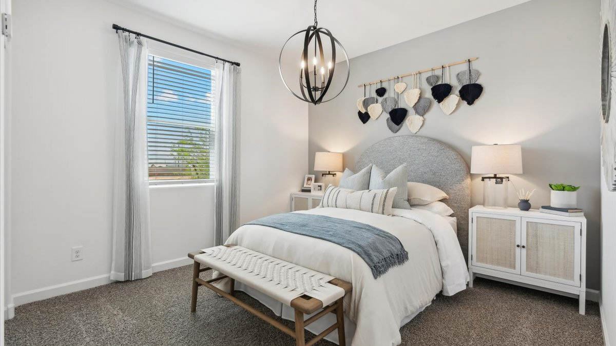 Comfortable guest bedroom featuring neutral-toned walls, carpeted flooring, and a large closet.