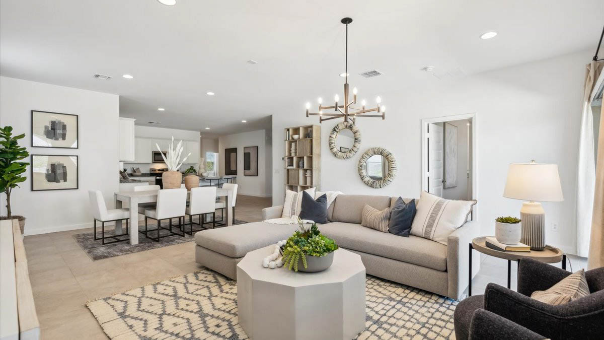 A well-organized living room that includes a kitchen and dining area, creating a warm and welcoming environment for gatherings.
