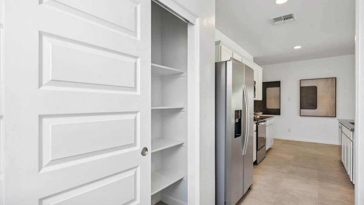 Bright and spacious kitchen with granite countertops, stainless steel appliances, and an island with bar seating.