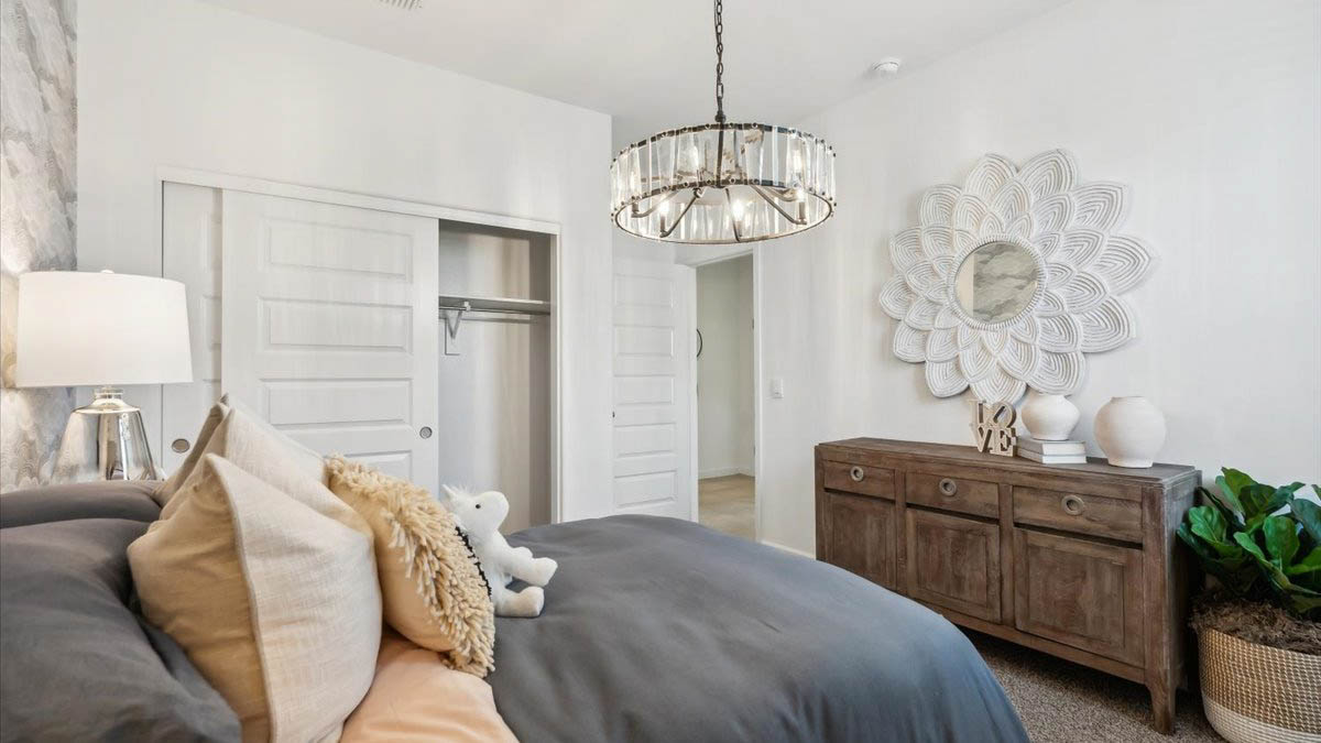 Comfortable guest bedroom featuring neutral-toned walls and a large closet.