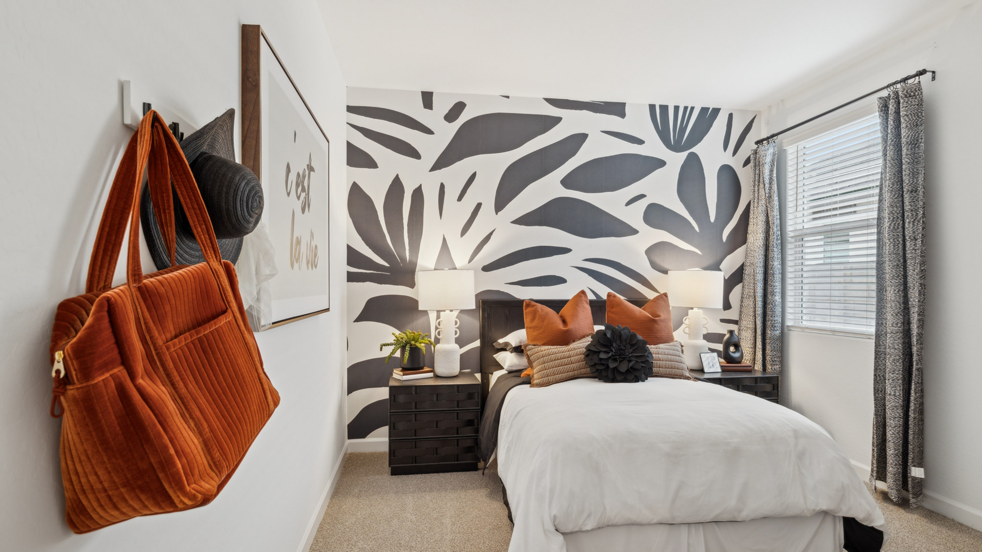 Comfortable guest bedroom featuring neutral-toned walls and a large closet.