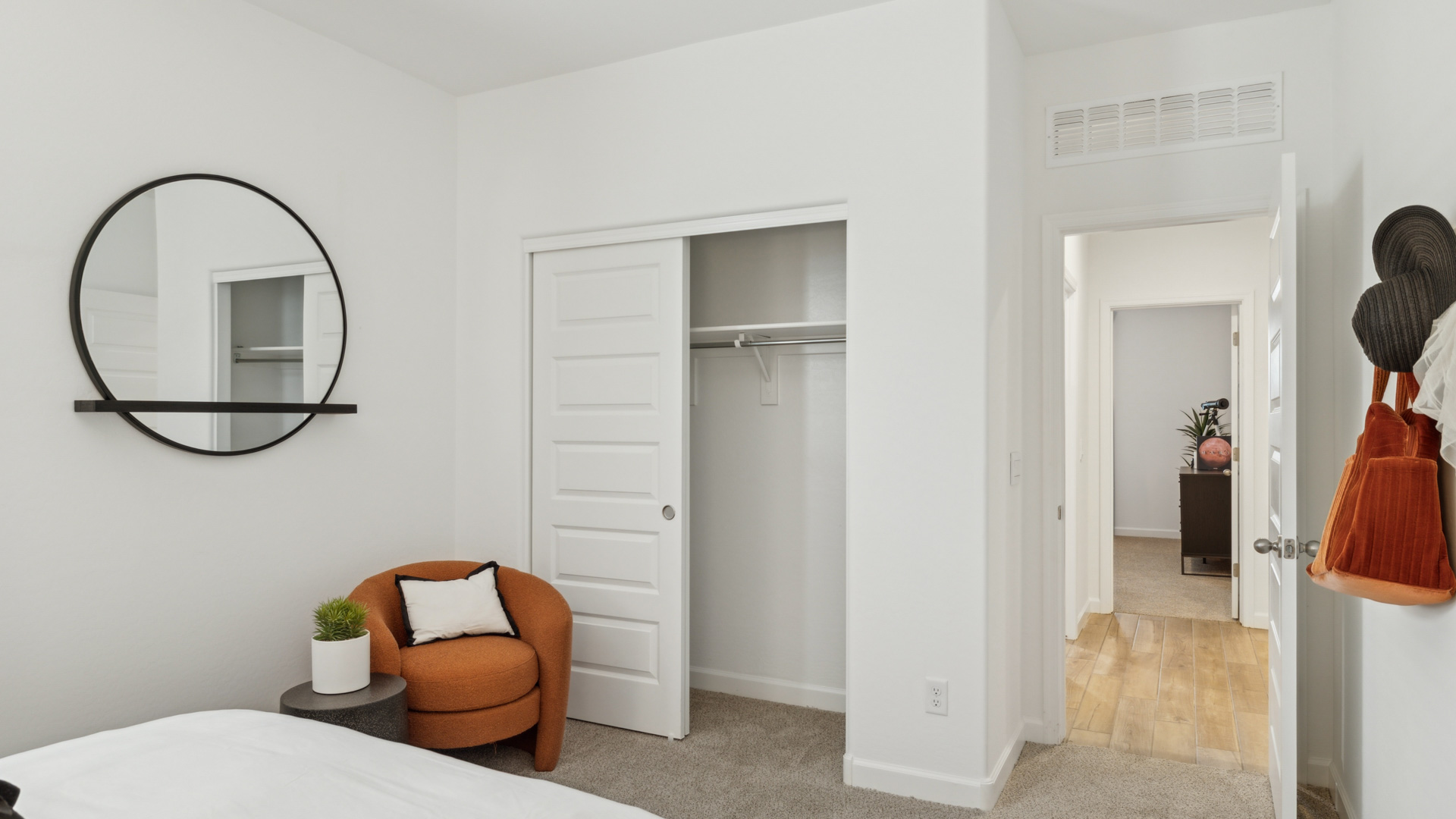 Comfortable guest bedroom featuring neutral-toned walls and a large closet.