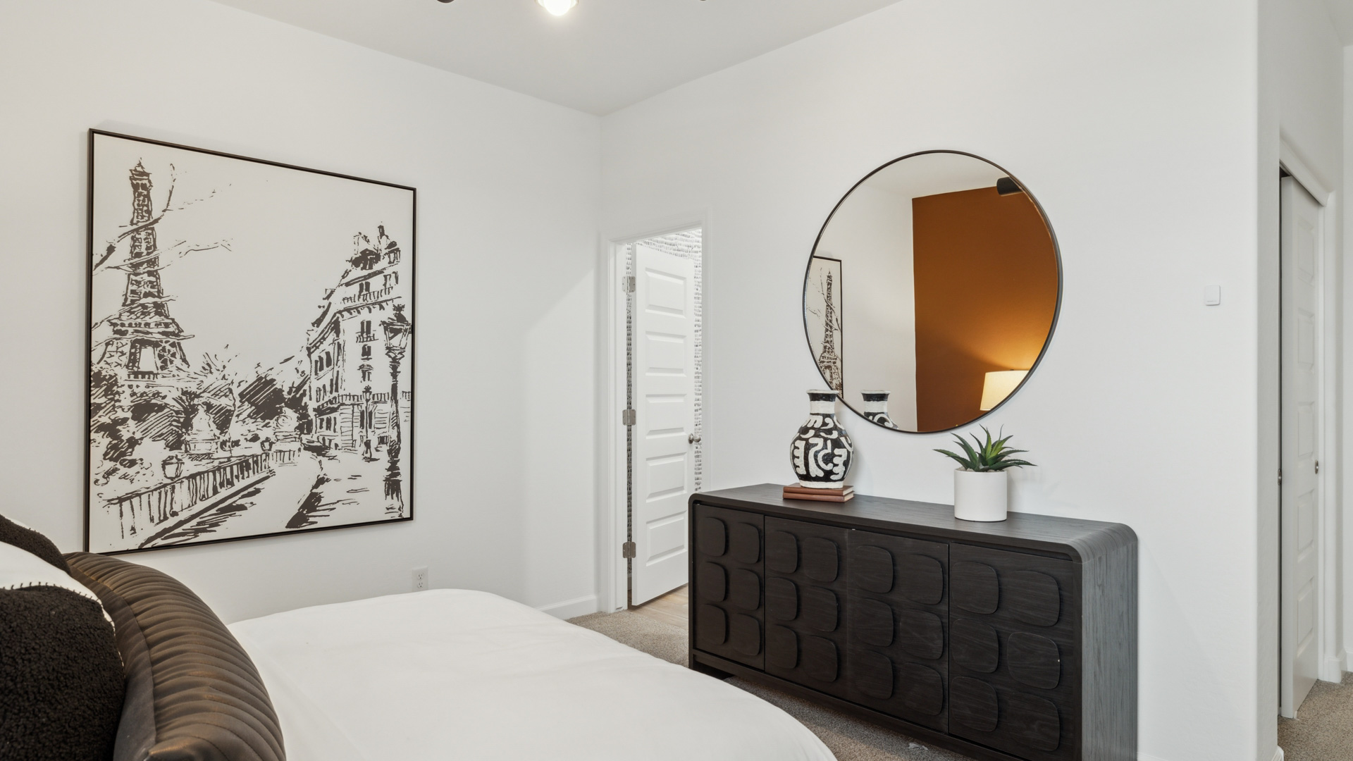 Comfortable guest bedroom featuring neutral-toned walls and a large closet.
