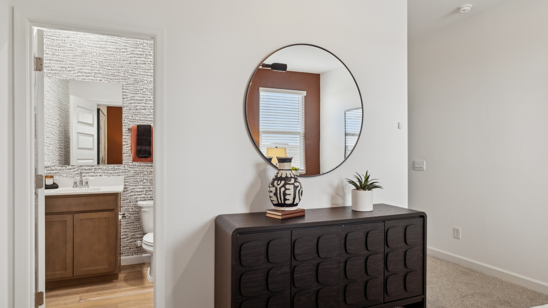 Attached to the guest bathroom is a well-designed bathroom emphasizing functionality and contemporary style.