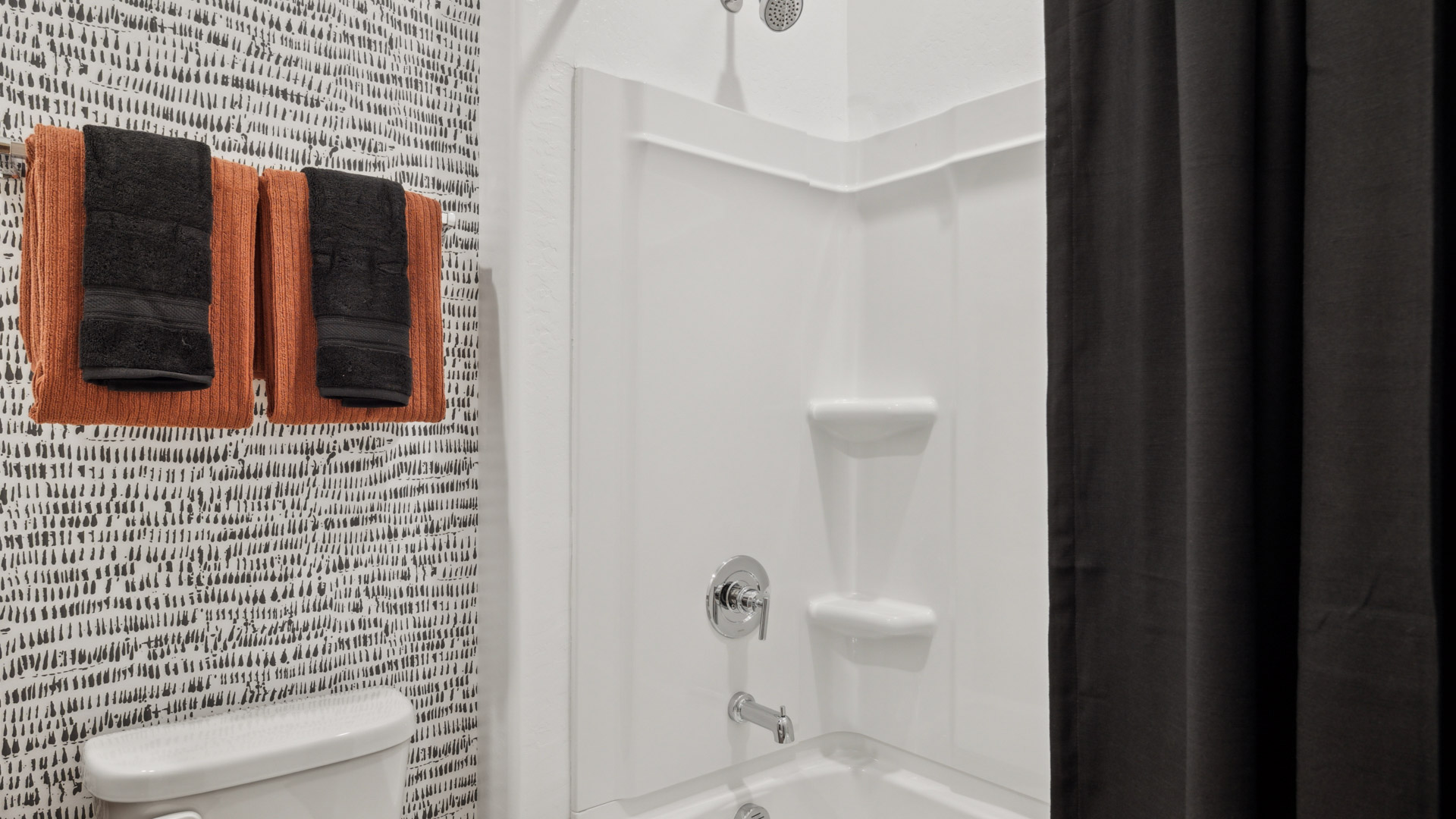Attached to the guest bathroom is a well-designed bathroom emphasizing functionality and contemporary style.