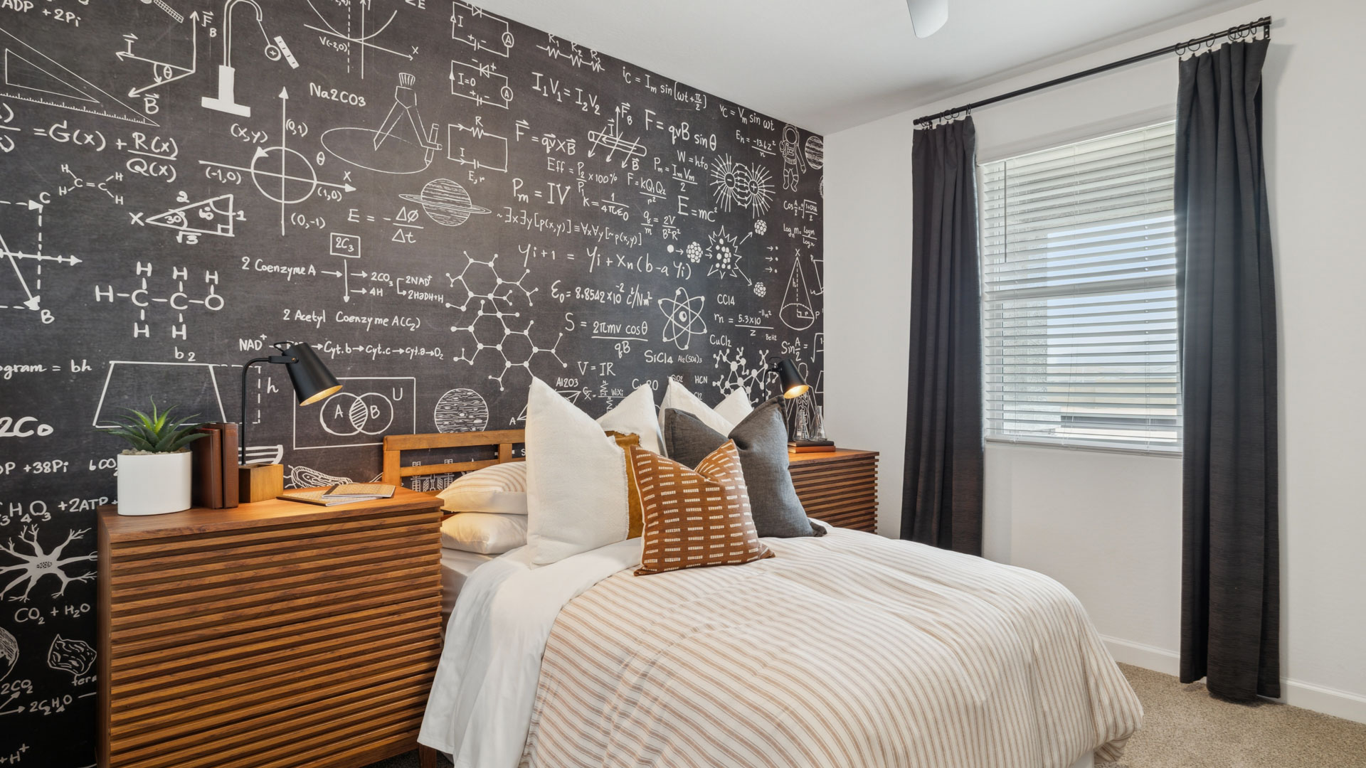 A vibrant kids' bedroom showcasing a neatly made bed, a stylish dresser, and a playful painting that adds charm.