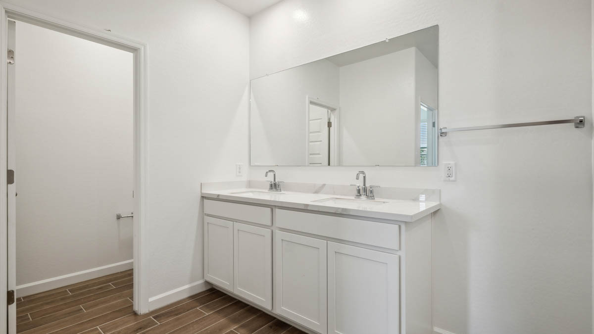 primary bathroom with dual vanities