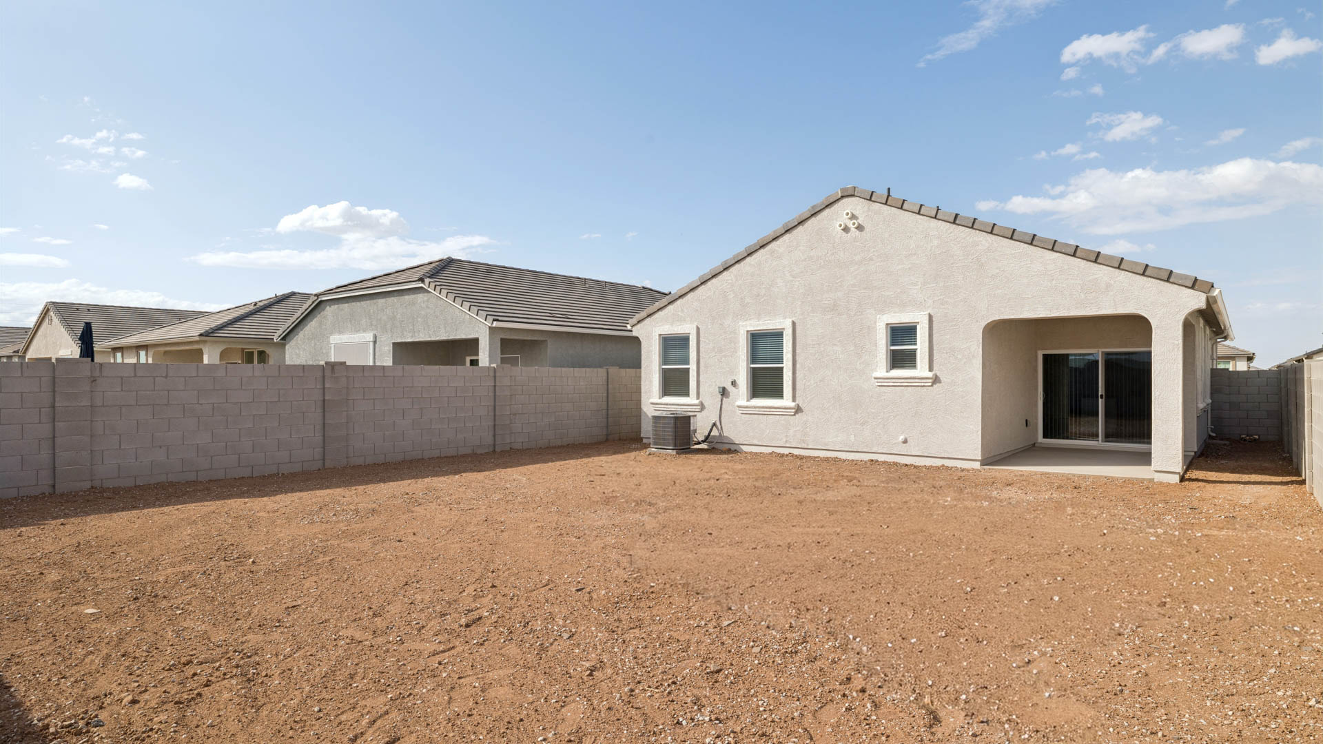 Large fenced-in backyard with a covered patio, perfect for outdoor entertaining.