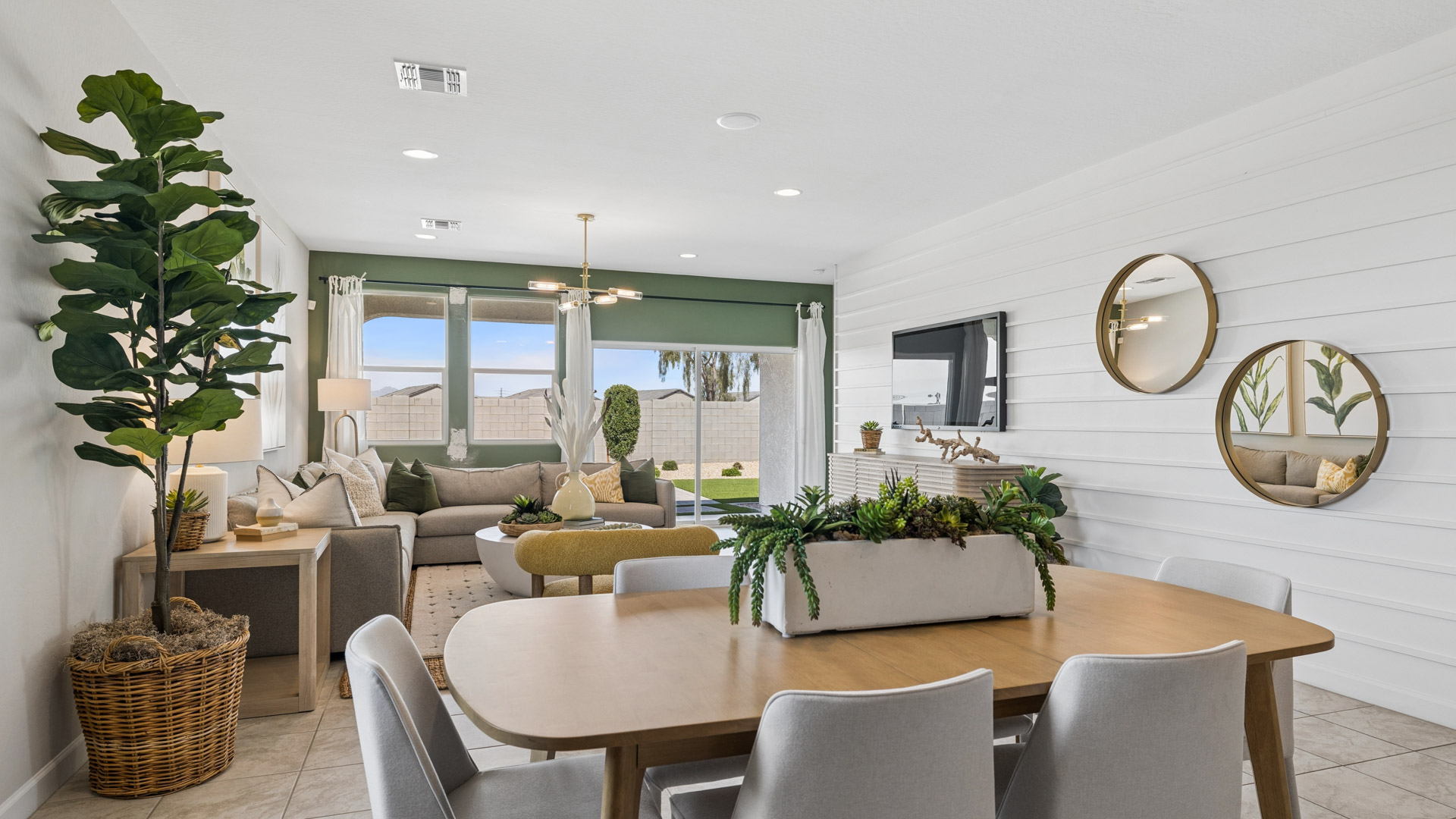 A well-organized living room that includes a kitchen and dining area, creating a warm and welcoming environment for gatherings.