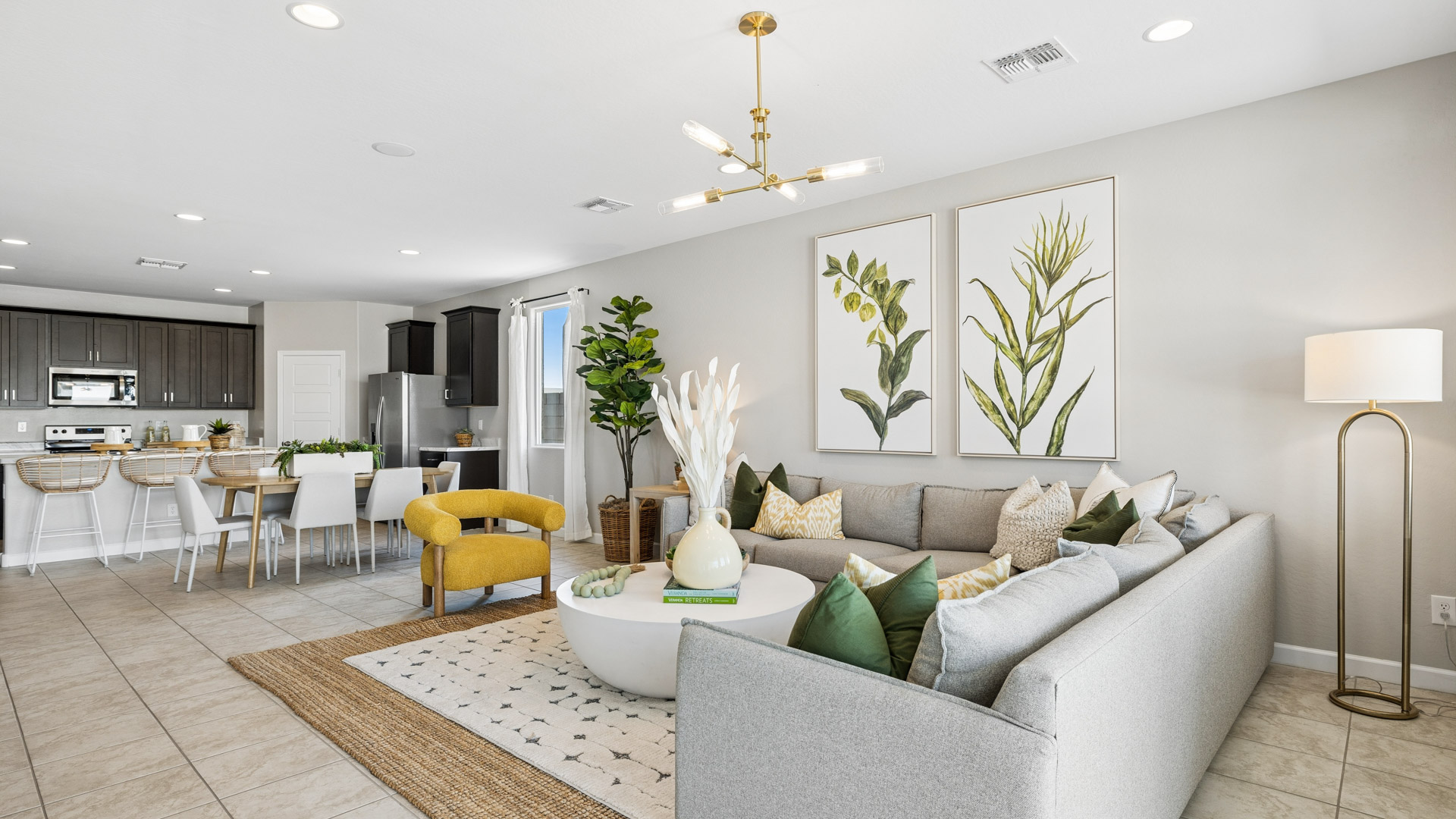 A well-organized living room that includes a kitchen and dining area, creating a warm and welcoming environment for gatherings.