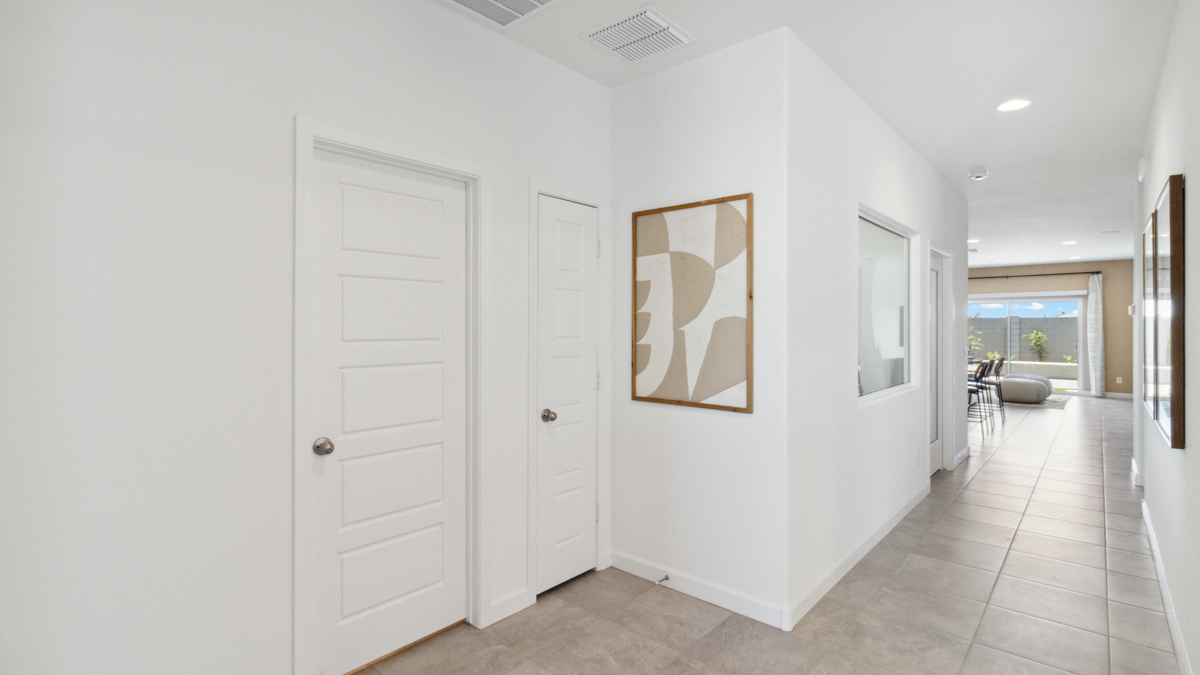 Entry hallway leading to living room and kitchen in the background.