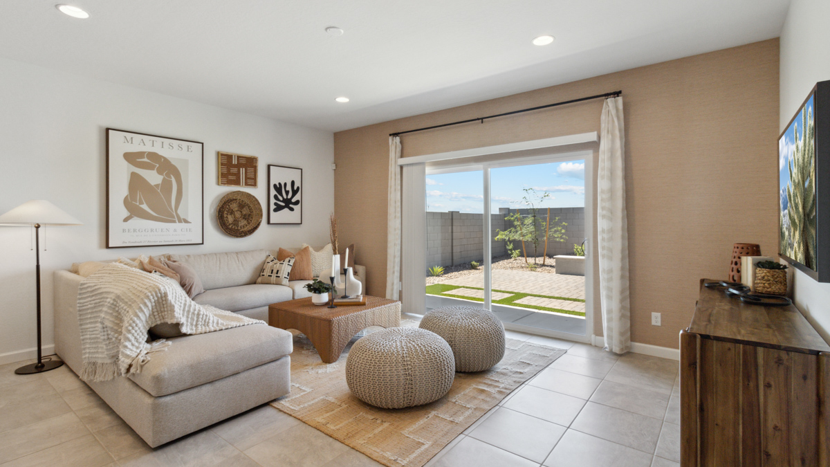 A well-organized living room that includes a kitchen and dining area, creating a warm and welcoming environment for gatherings.