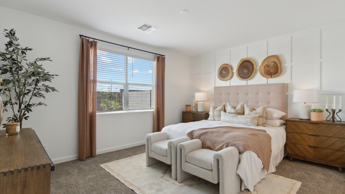 A spacious primary bedroom emphasizing open space and natural lighting.