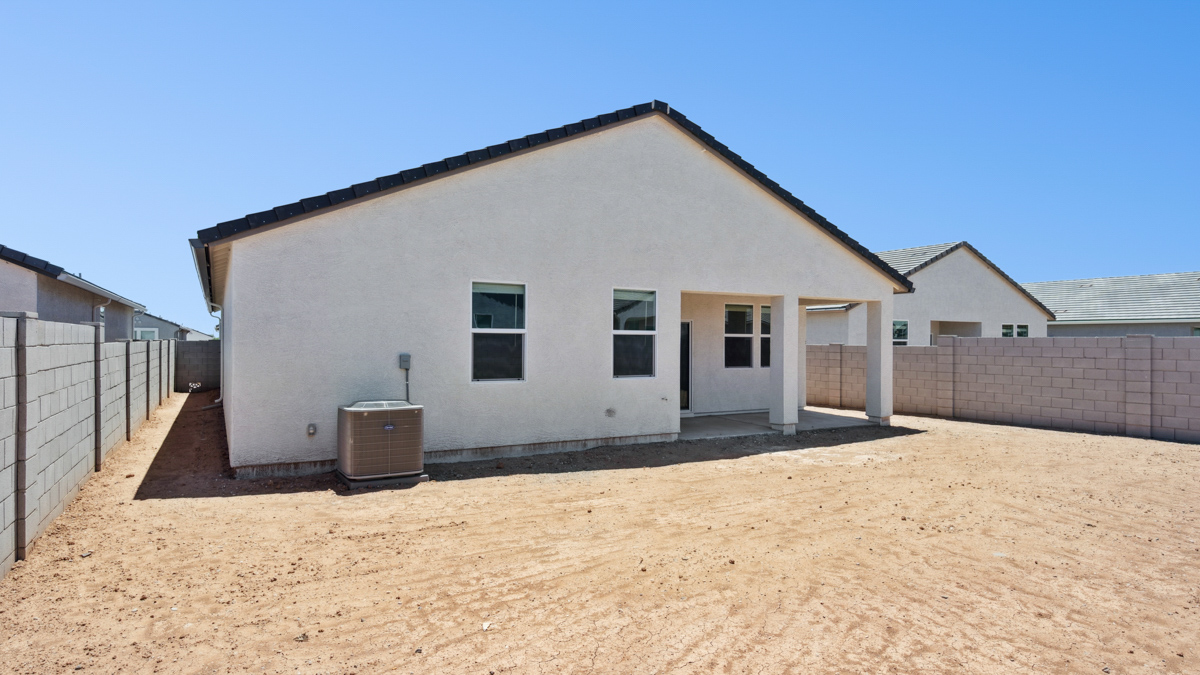 Large fenced-in backyard with a covered patio, perfect for outdoor entertaining.