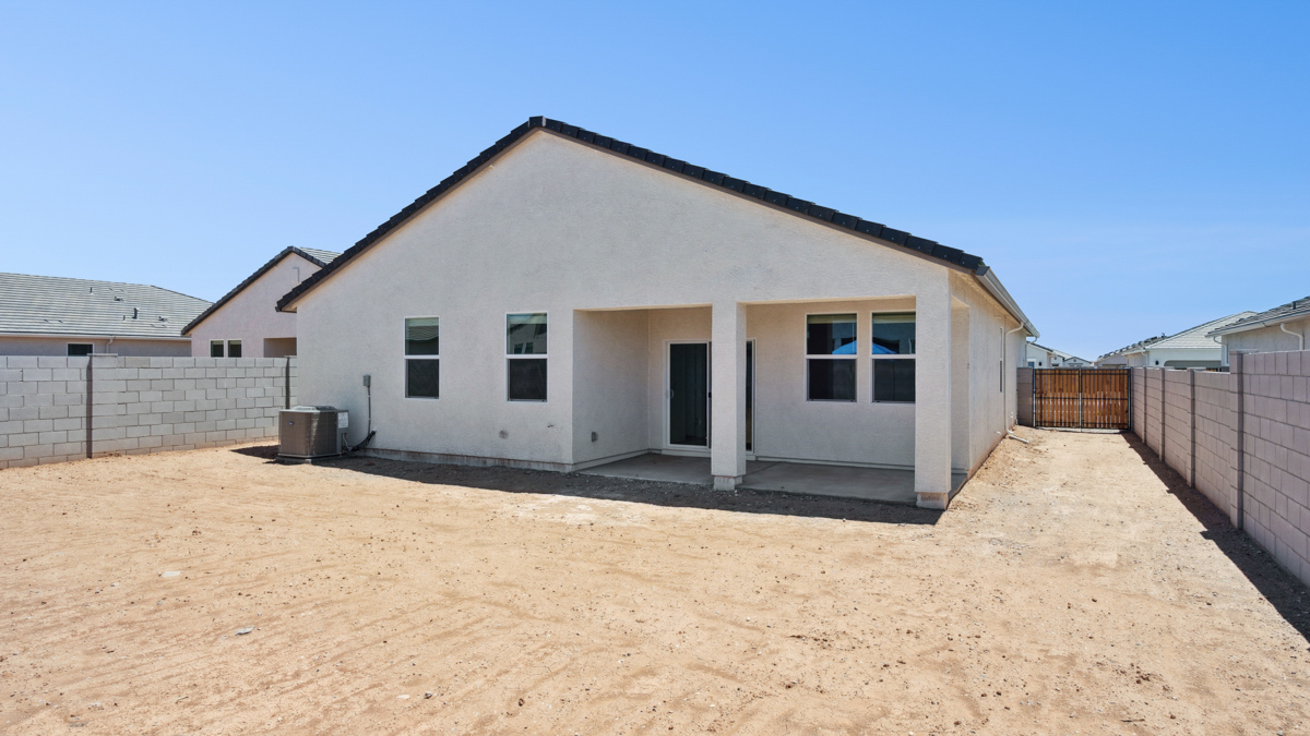 Large fenced-in backyard with a covered patio, perfect for outdoor entertaining.