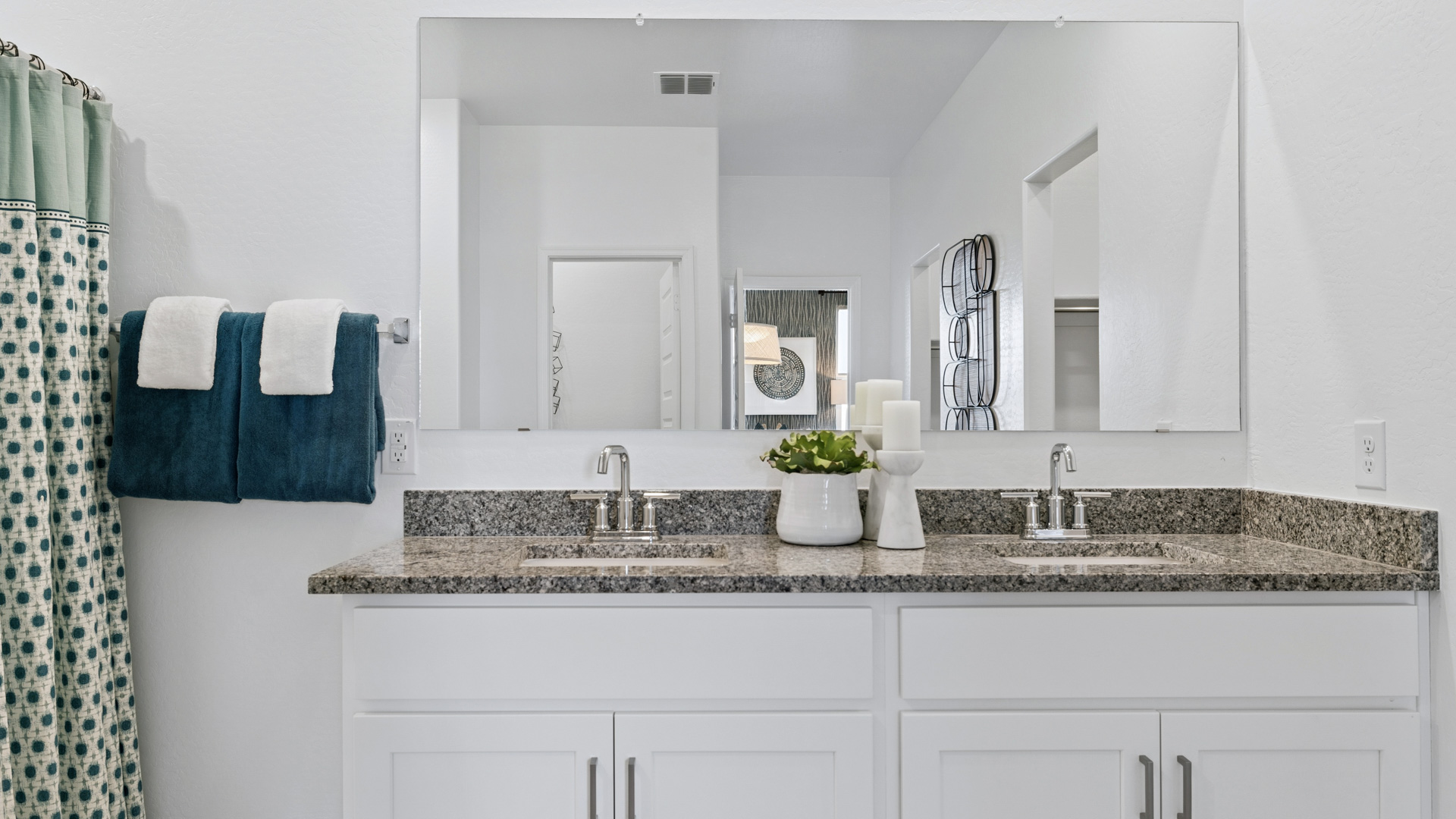 primary bathroom with dual vanities