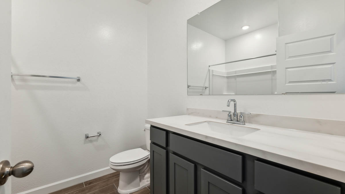Guest bathroom with one sink, shower, and a toilet.