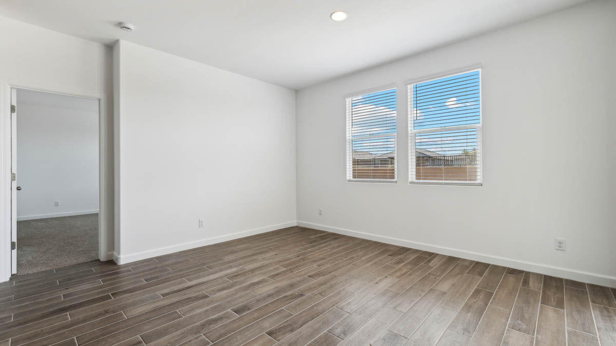 Dining area with large windows and hardwood floors.