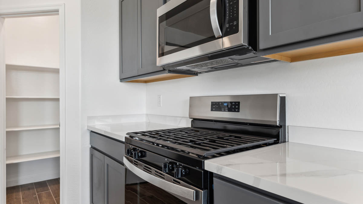 Kitchen stove with ample cabinet space and pantry connected.