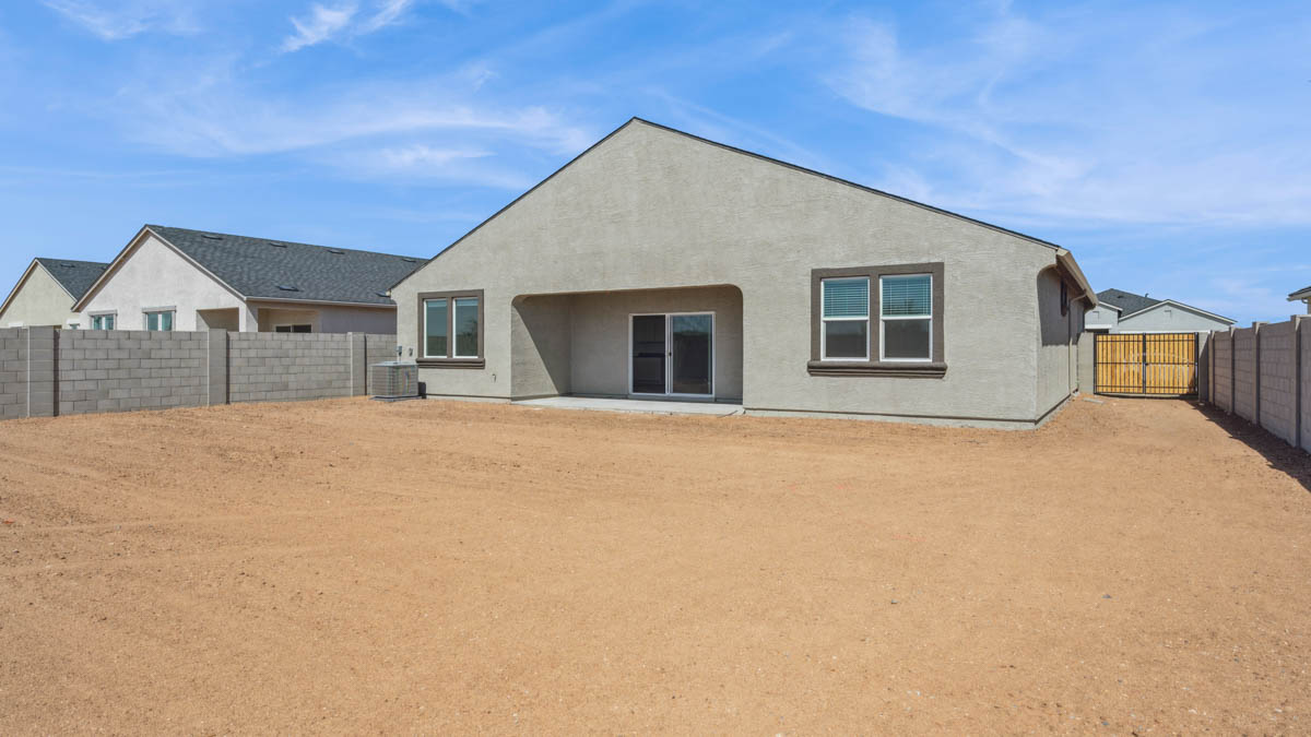 Large fenced-in backyard with a covered patio, perfect for outdoor entertaining.