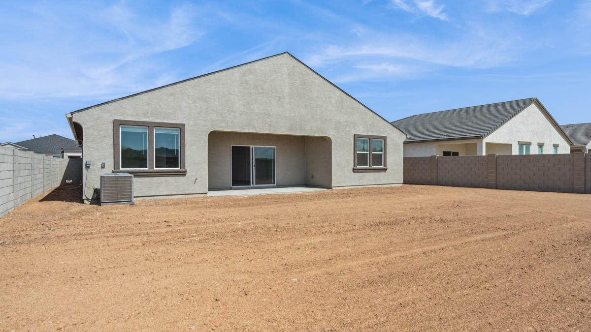 Large fenced-in backyard with a covered patio, perfect for outdoor entertaining.