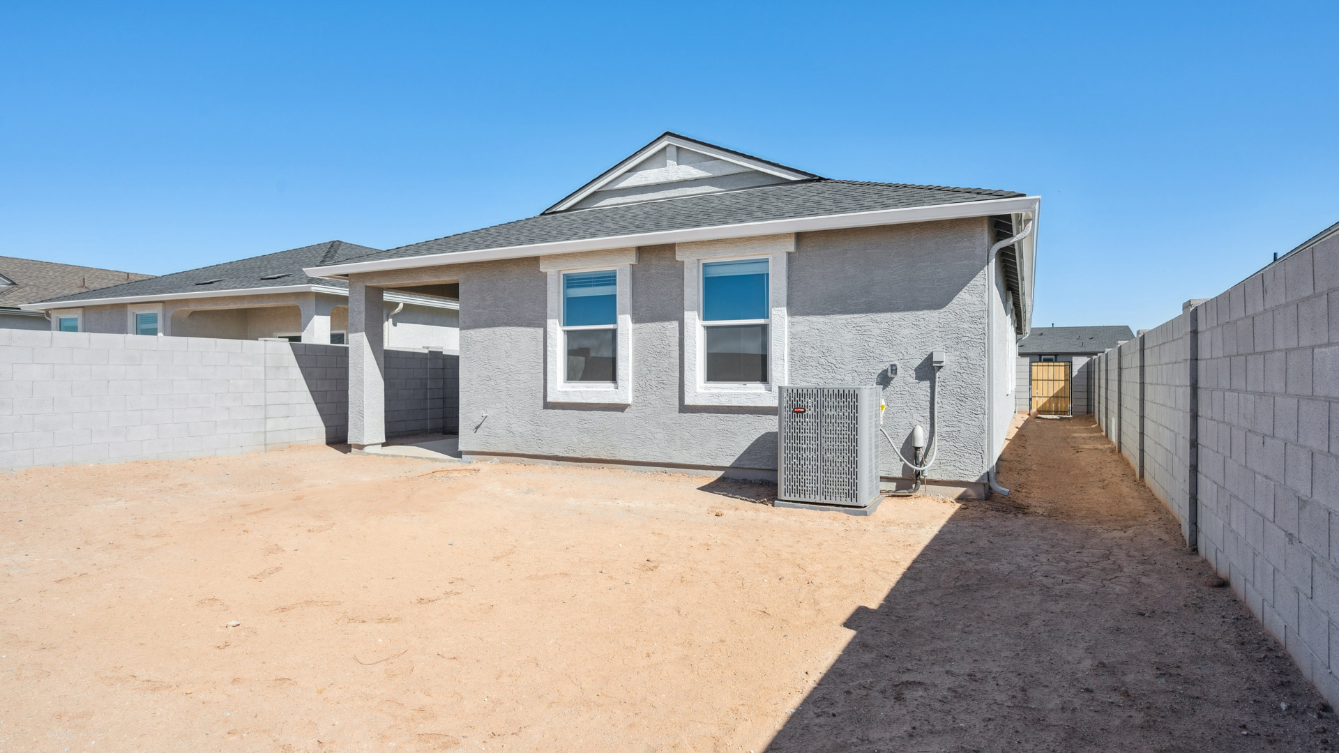 Large fenced-in backyard with a covered patio, perfect for outdoor entertaining.