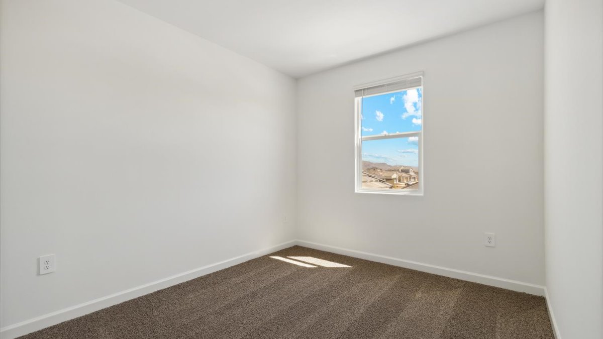 Comfortable guest bedroom featuring neutral-toned walls and a large closet.