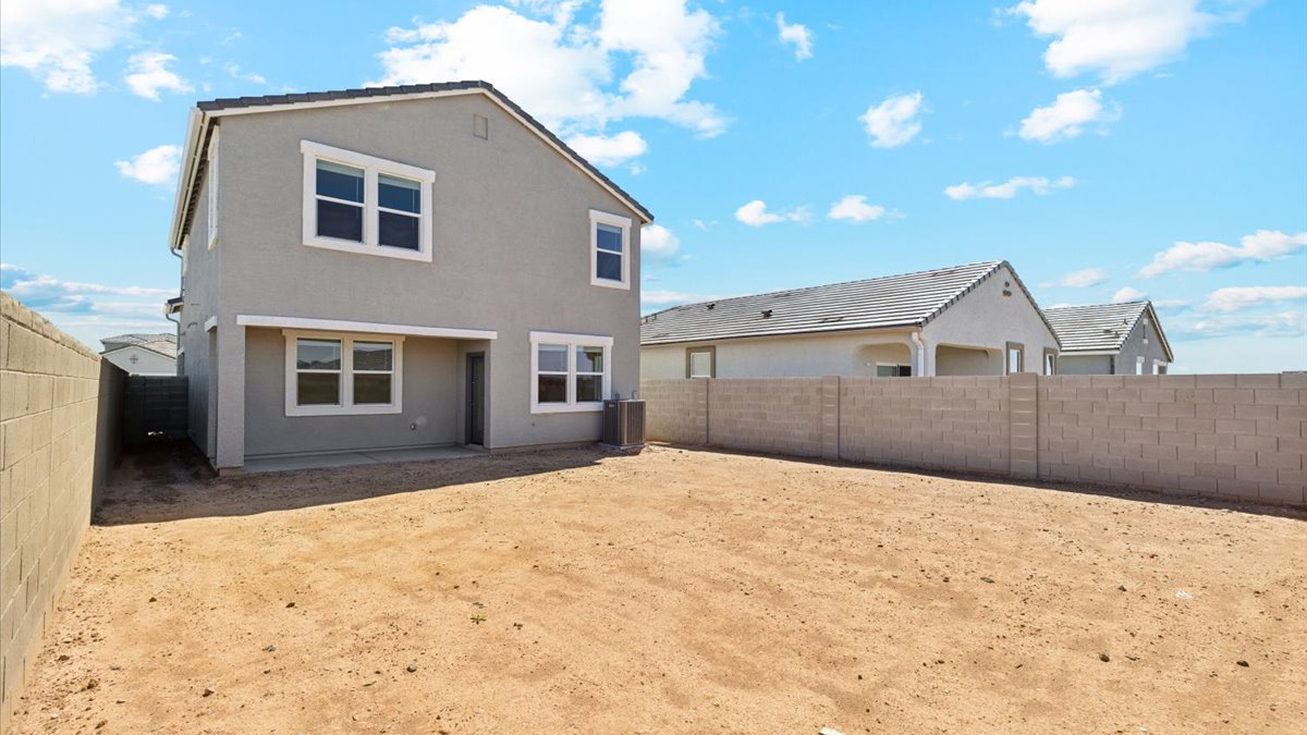 Large fenced-in backyard with a covered patio, perfect for outdoor entertaining.
