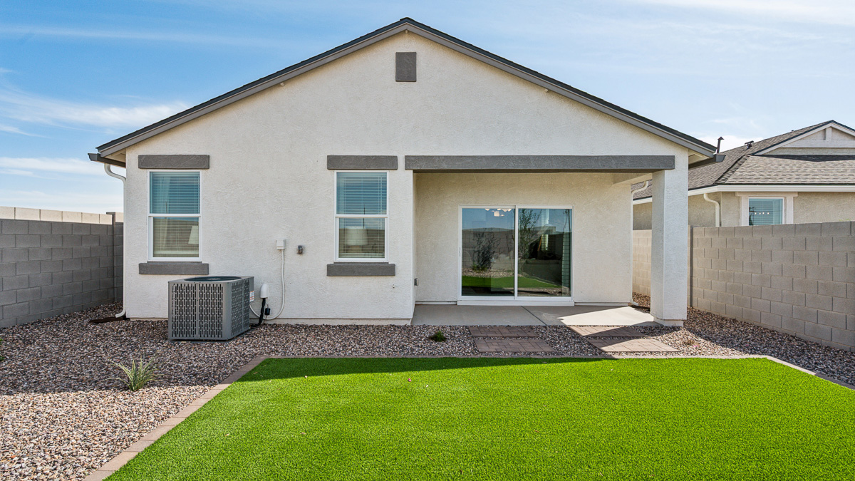 utdoor covered patio with seating area overlooking a well-maintained lawn, perfect for relaxation