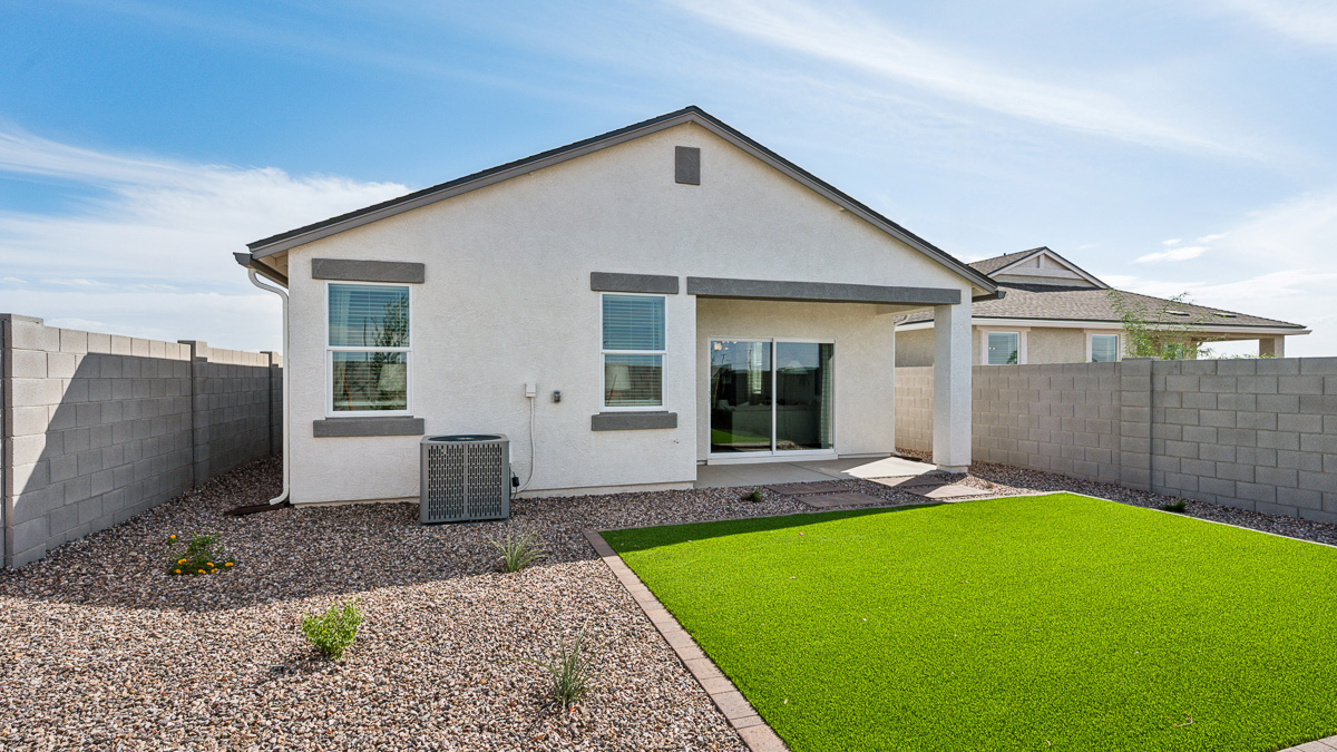utdoor covered patio with seating area overlooking a well-maintained lawn, perfect for relaxation