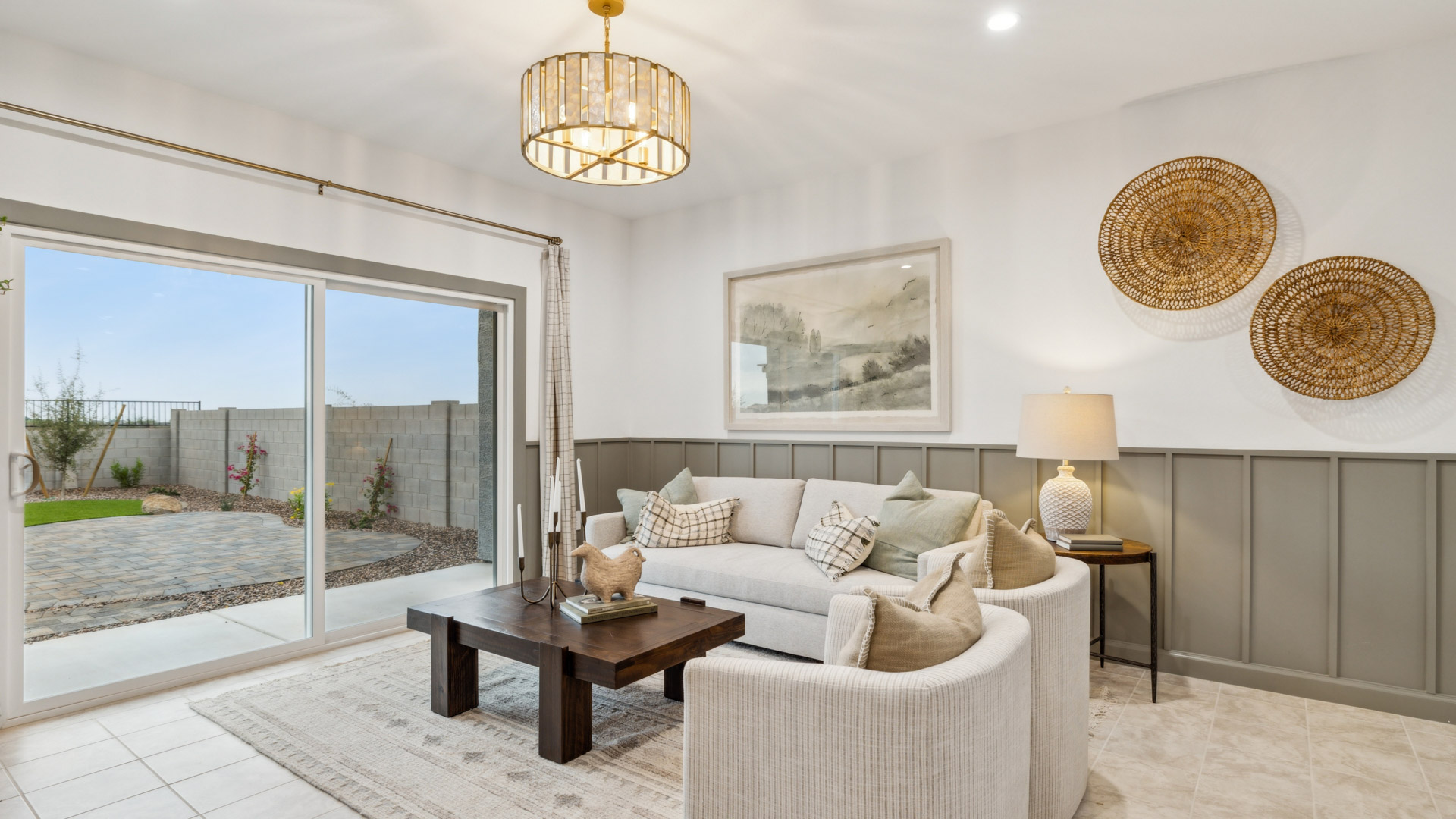 A cozy living room featuring a comfortable couch, a stylish coffee table, and an elegant painting on the wall.