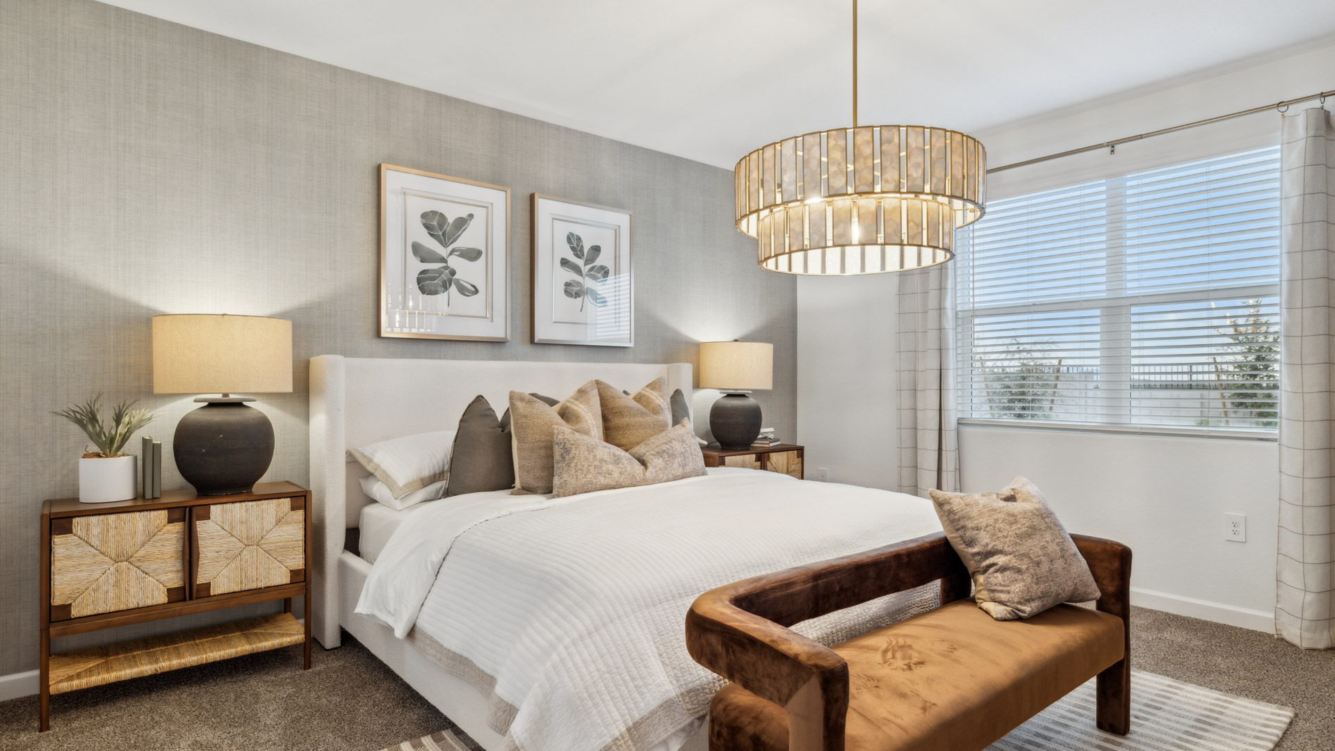 A spacious primary bedroom emphasizing open space and natural lighting.