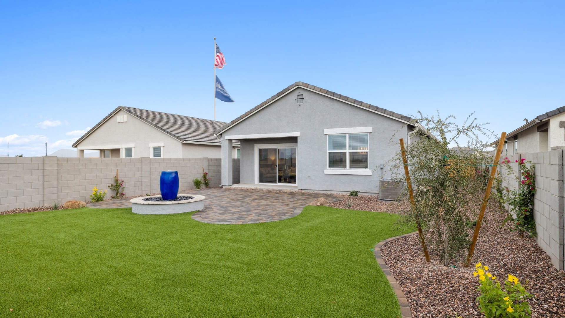 Large fenced-in backyard with a covered patio, perfect for outdoor entertaining.