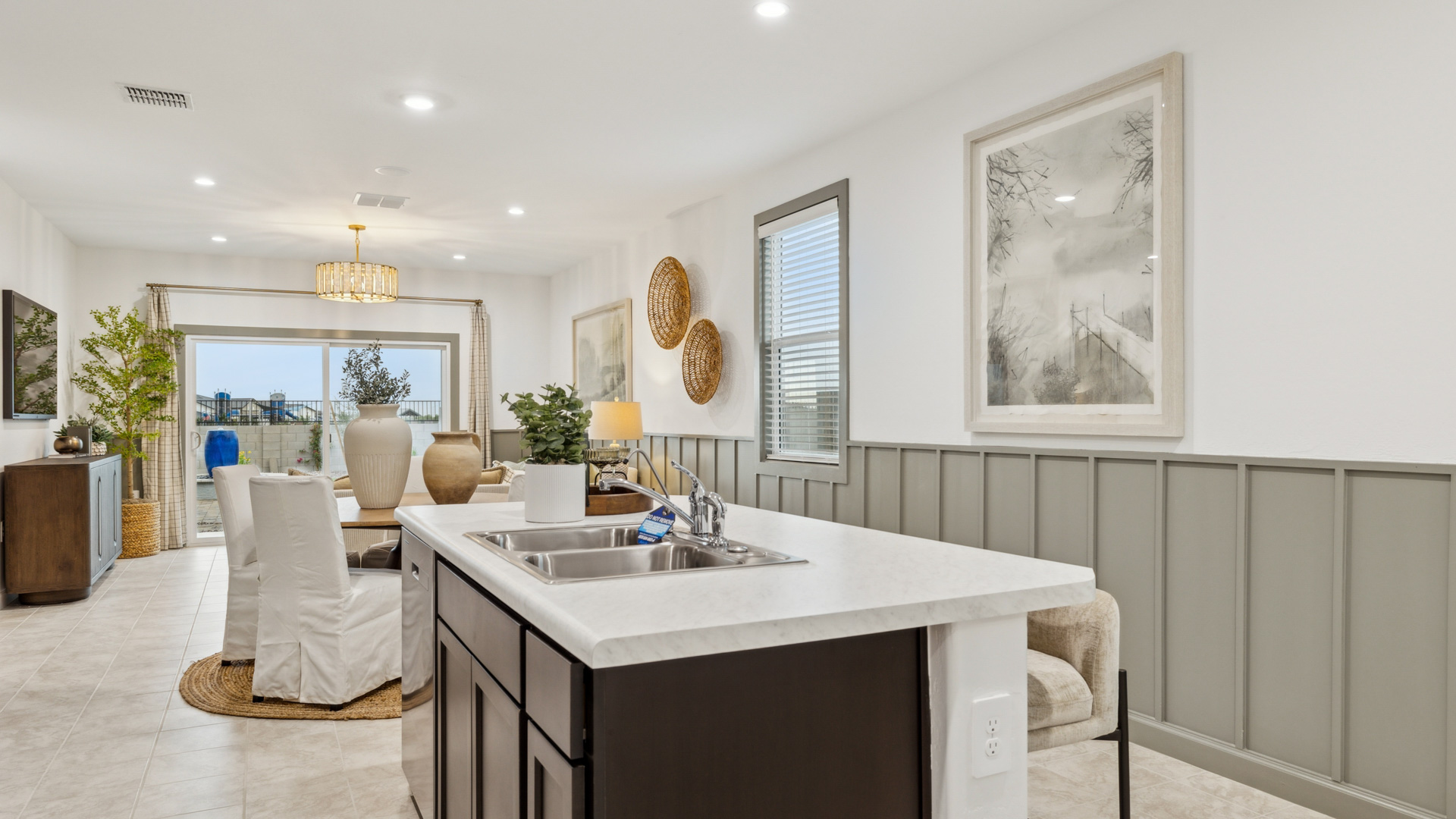 Contemporary kitchen adorned with espresso cabinets seamlessly integrated into an open dining area layout.