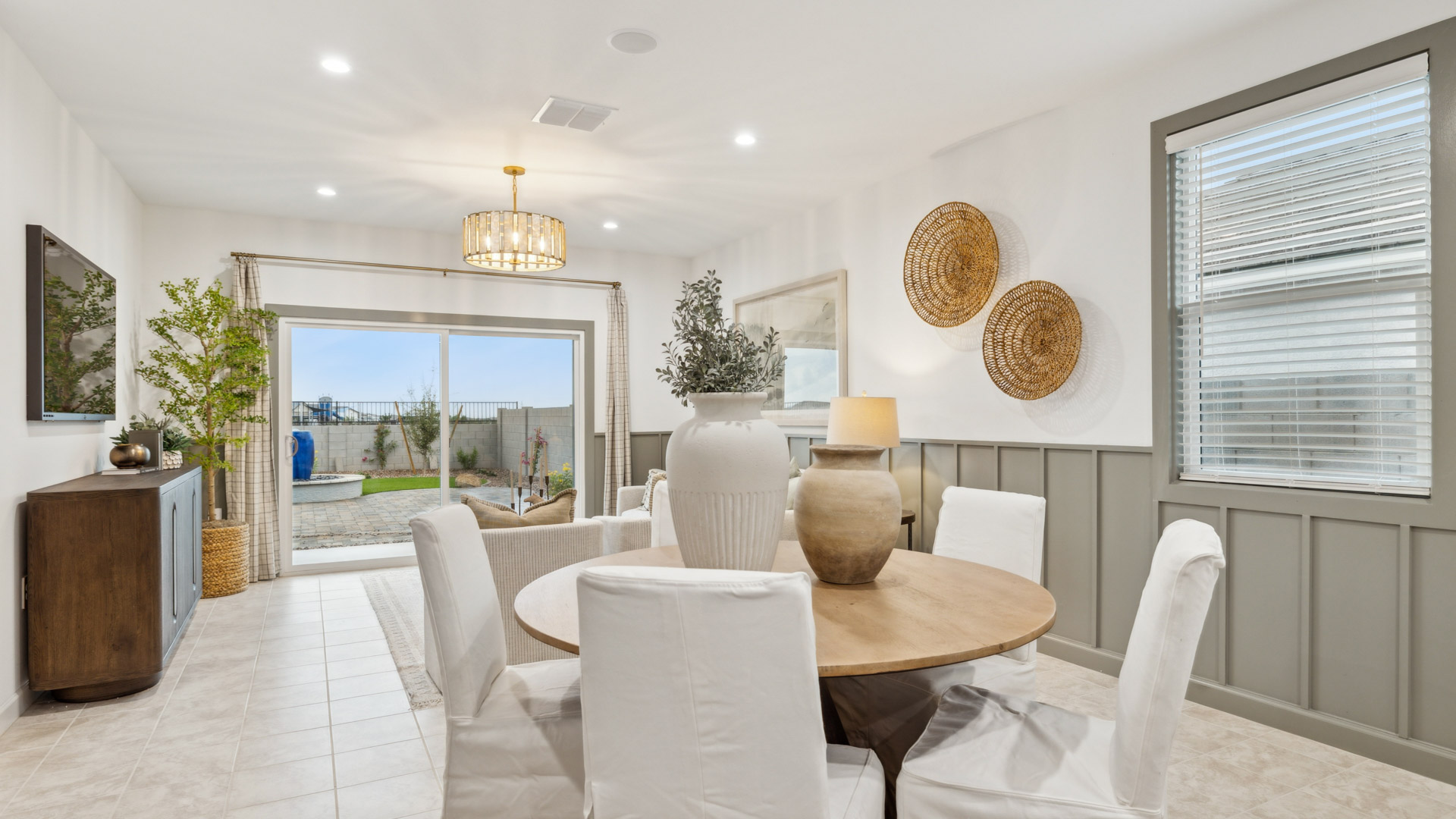 Spacious dining area with vinyl wood flooring, large window and tall ceiling.