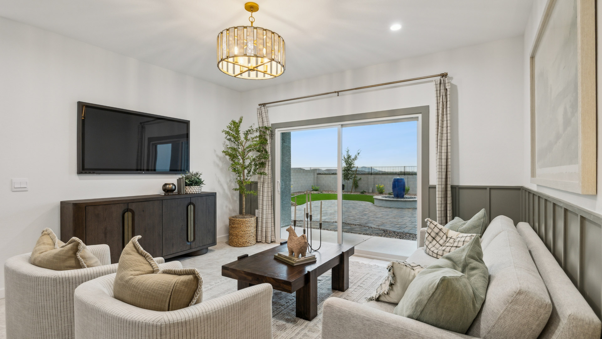 A cozy living room featuring a comfortable couch, a stylish coffee table, and an elegant painting on the wall.