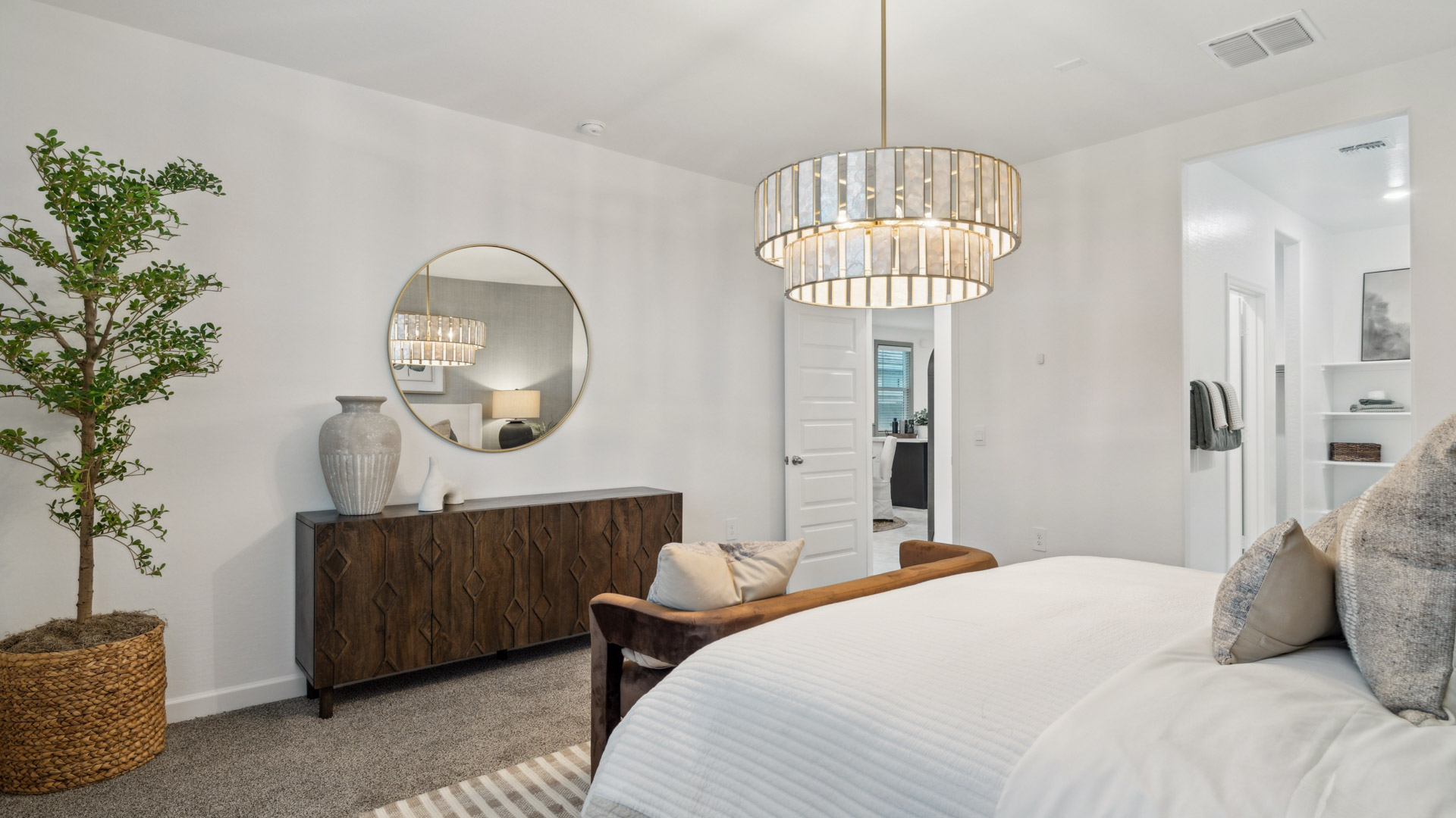 Primary bedroom with plush carpeting and a large walk-in closet.