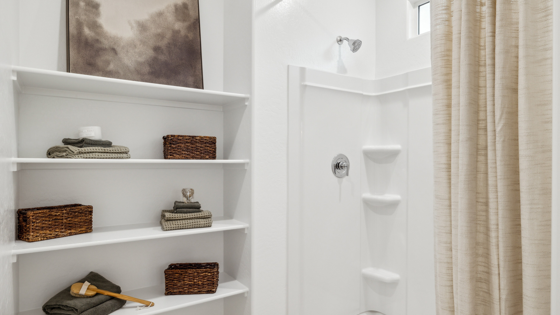 Modern primary bathroom with double vanities, porcelain countertops with a walk-in shower and a walk-in closet.