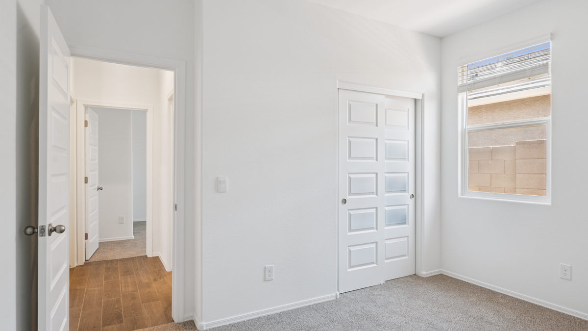 Modern primary bathroom with double vanities, quartz countertops with a walk-in shower and a walk-in closet.