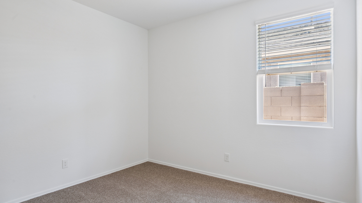 Comfortable guest bedroom featuring neutral-toned walls and a large closet.
