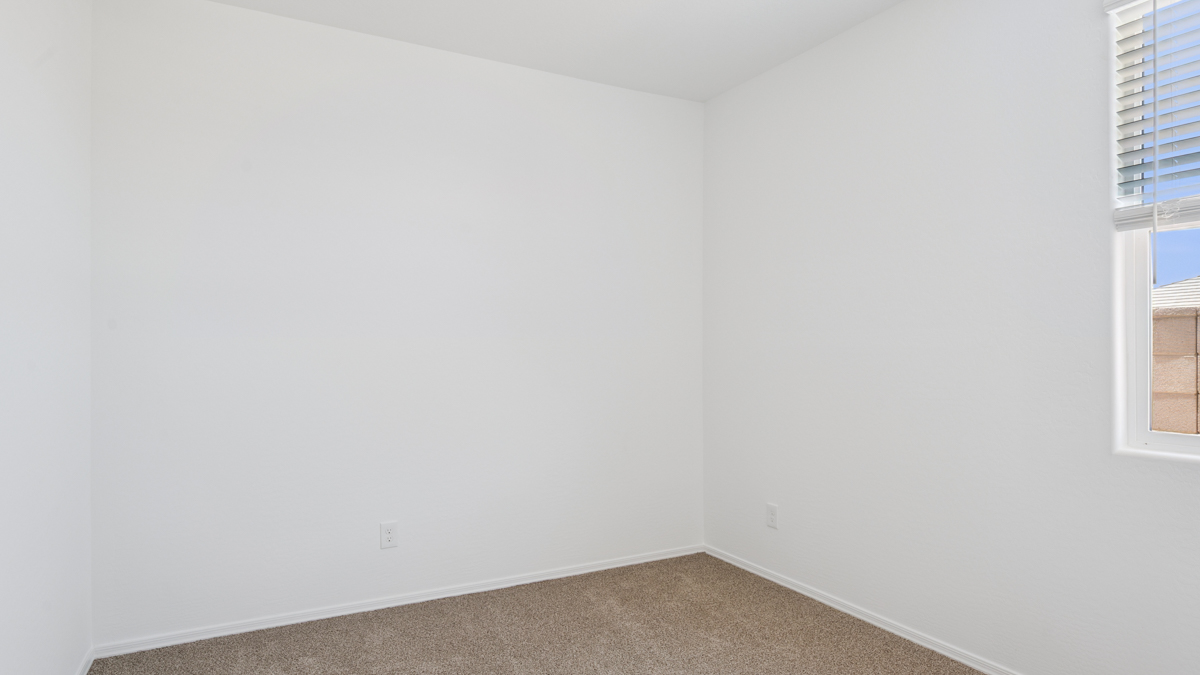 Comfortable guest bedroom featuring neutral-toned walls and a large closet.
