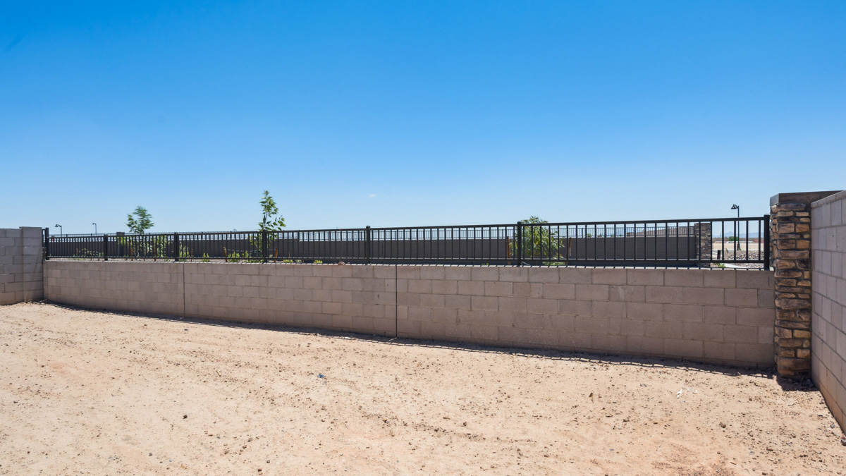 Large fenced-in backyard with a covered patio, perfect for outdoor entertaining.