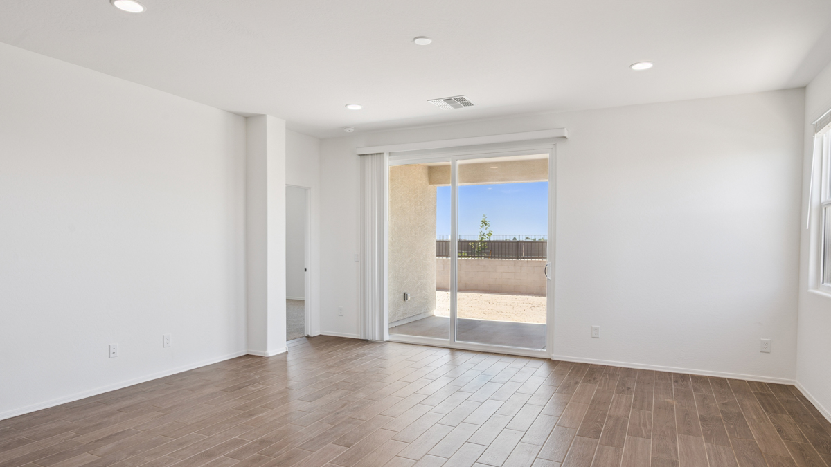 A well-organized living room that includes a kitchen and dining area, creating a warm and welcoming environment for gatherings.