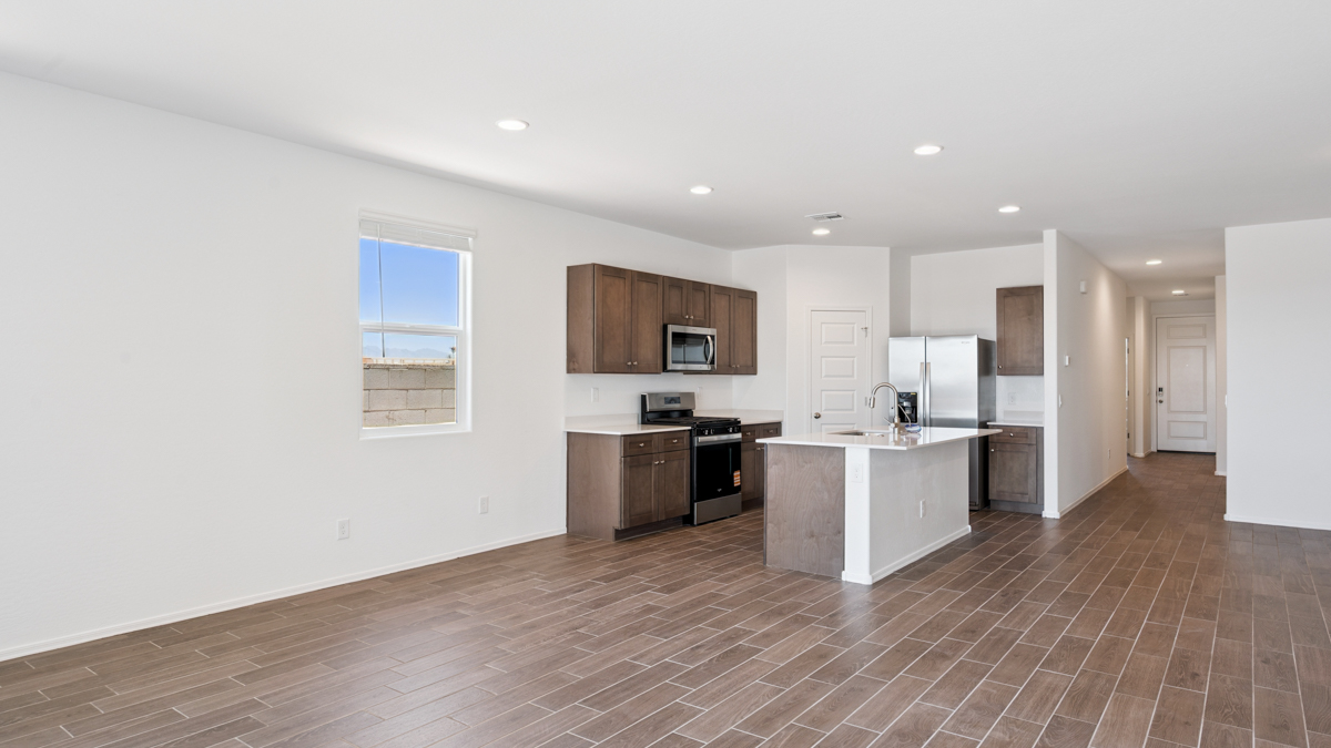 A well-organized living room that includes a kitchen and dining area, creating a warm and welcoming environment for gatherings.