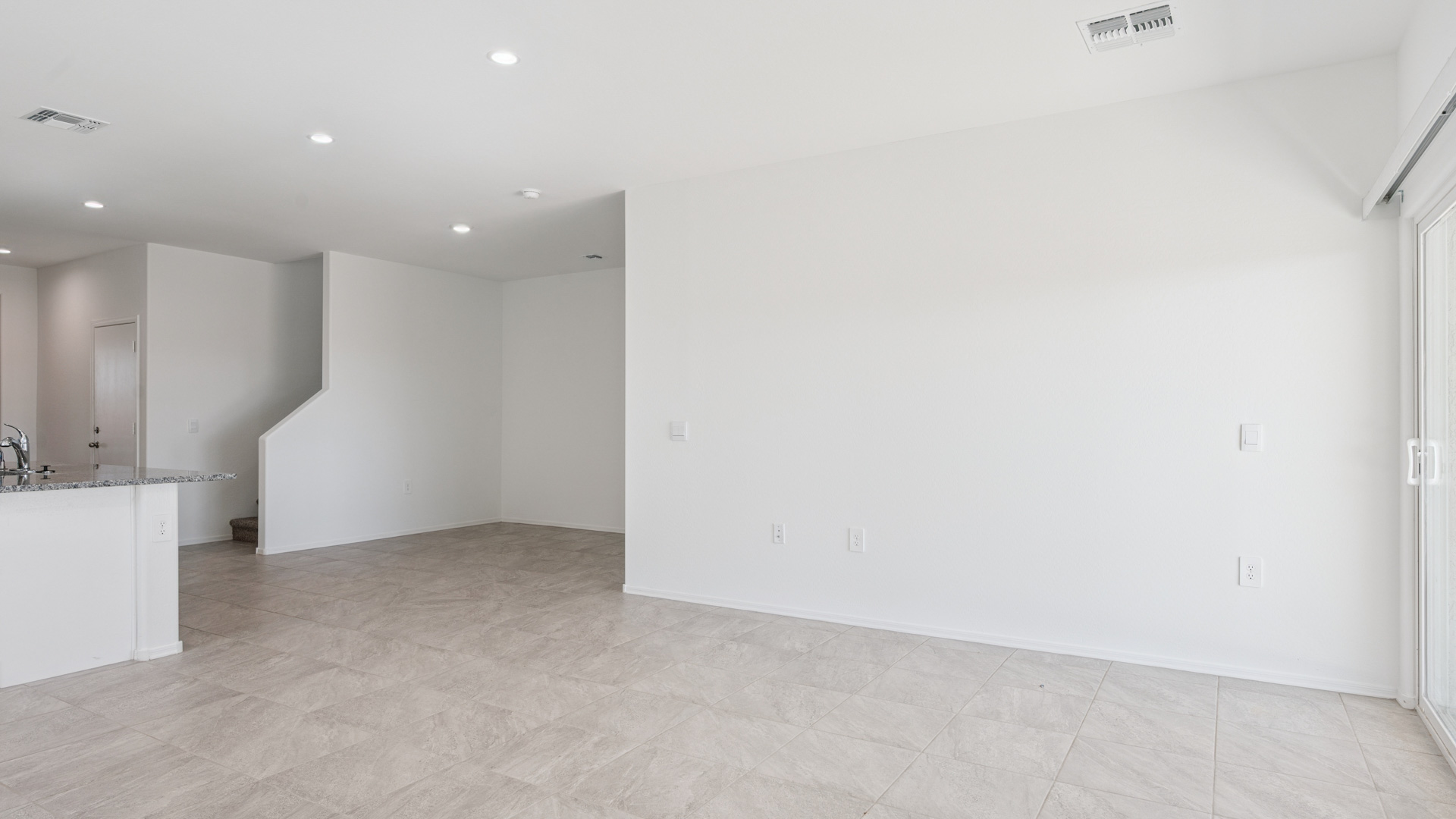 A well-organized living room that includes a kitchen and dining area, creating a warm and welcoming environment for gatherings.