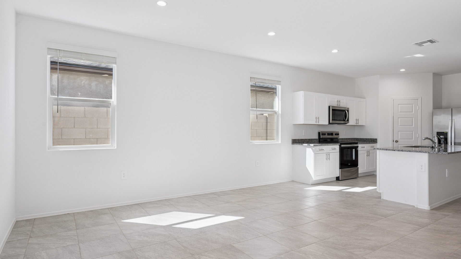 A well-organized living room that includes a kitchen and dining area, creating a warm and welcoming environment for gatherings.