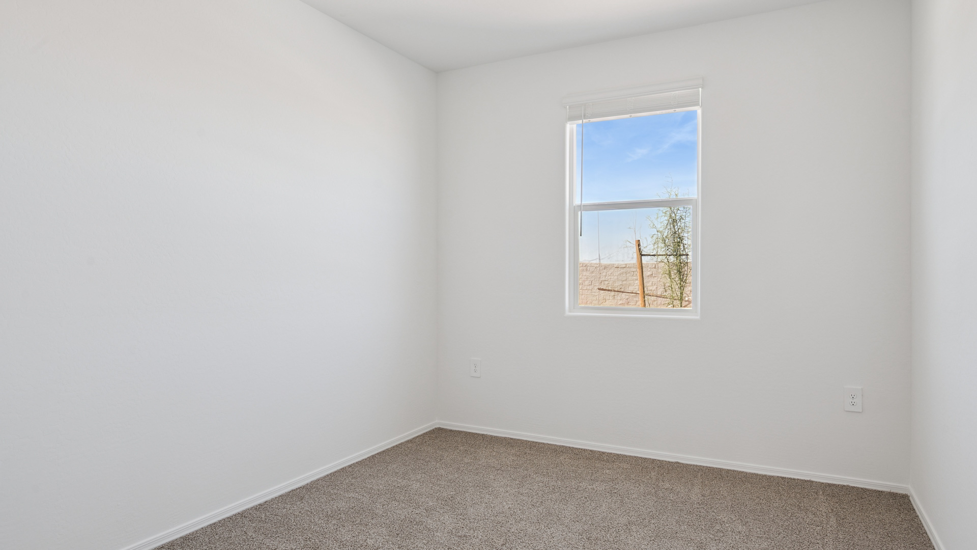 Comfortable guest bedroom featuring neutral-toned walls and a large closet.